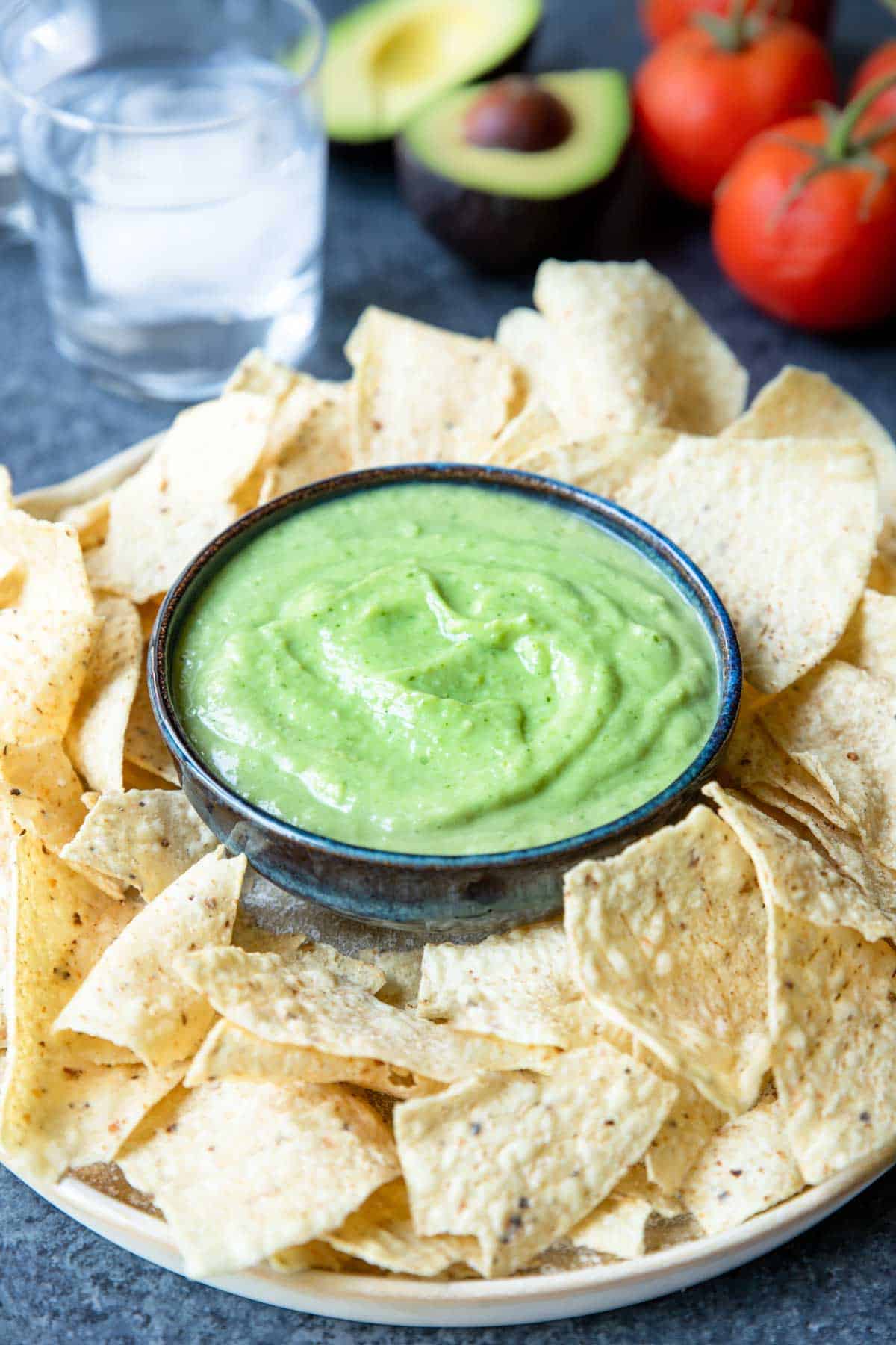 creamy avocado salsa in a bowl with chips 