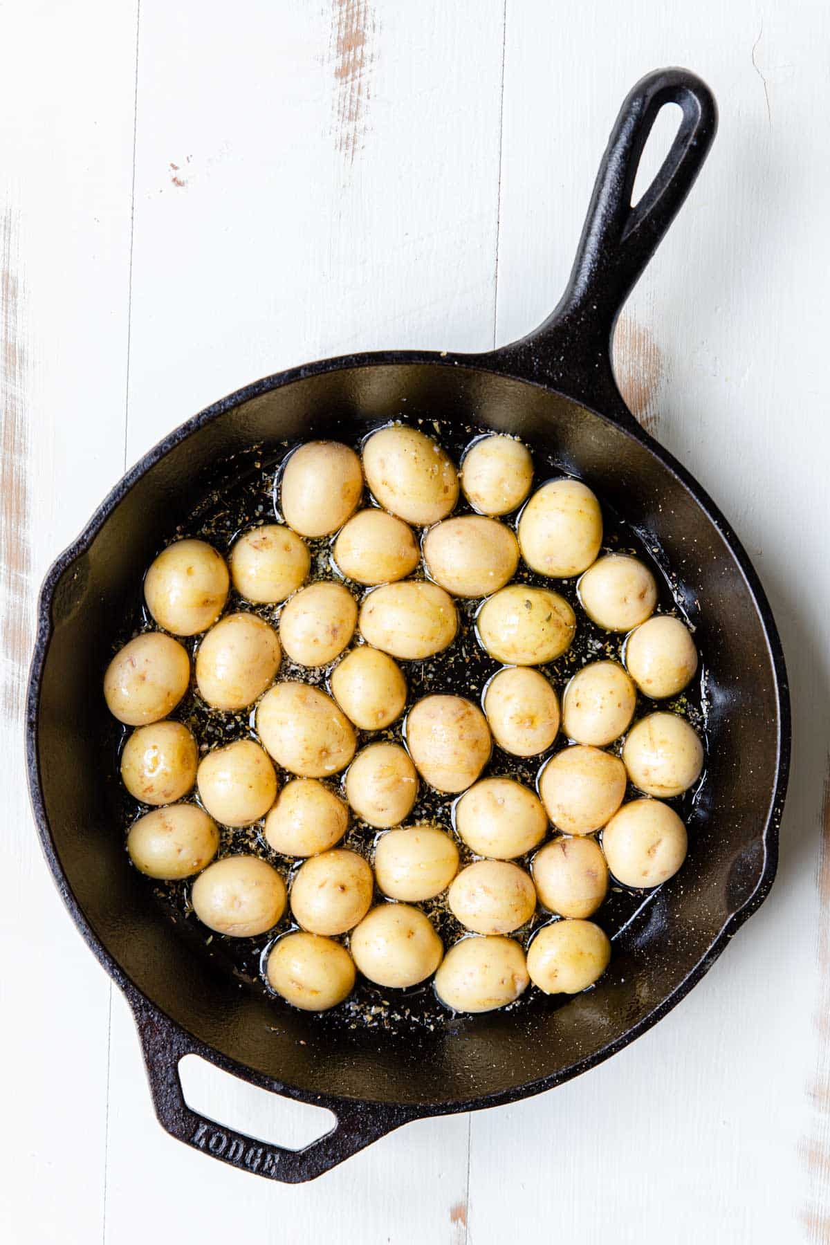 yukon gold potatoes cut in half and placed cut side down in a pan