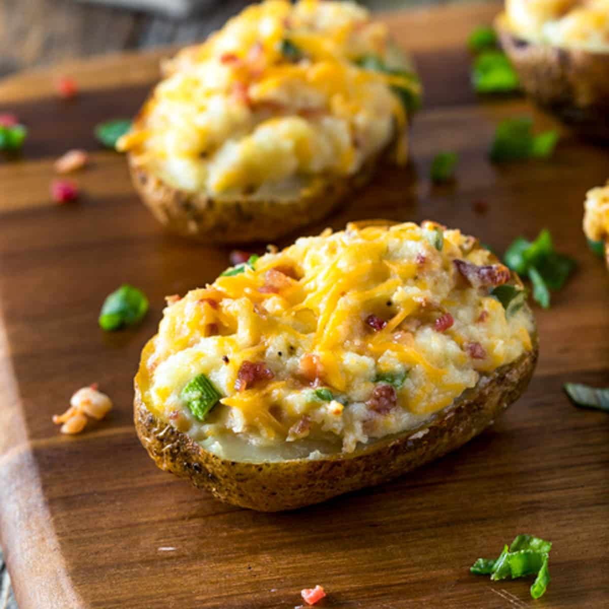 a loaded baked potato on a cutting board