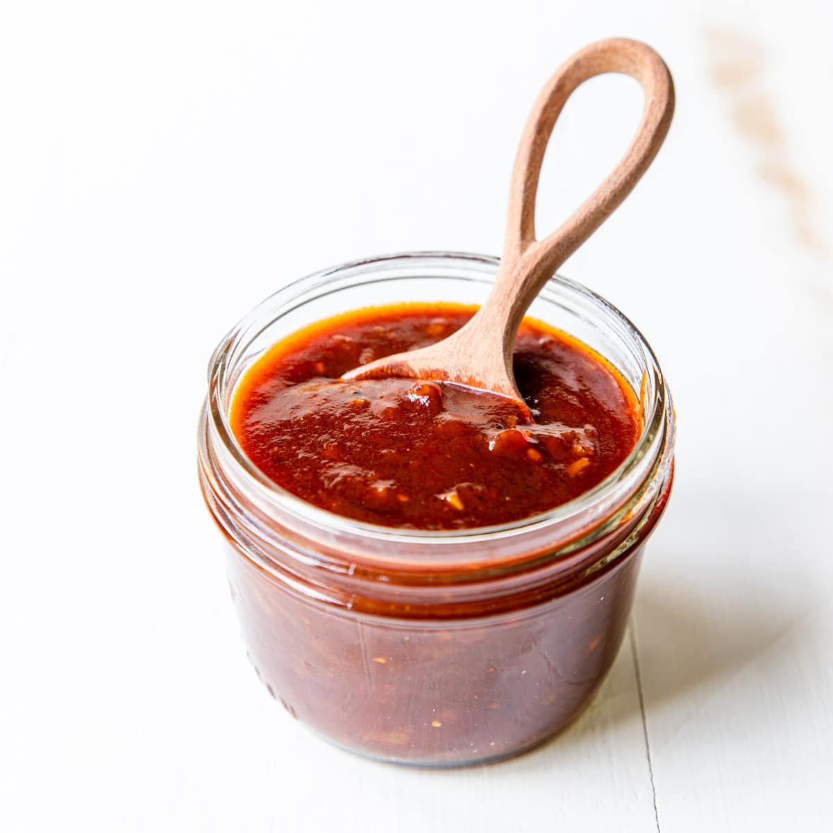 a mason jar full of homemade bbq sauce