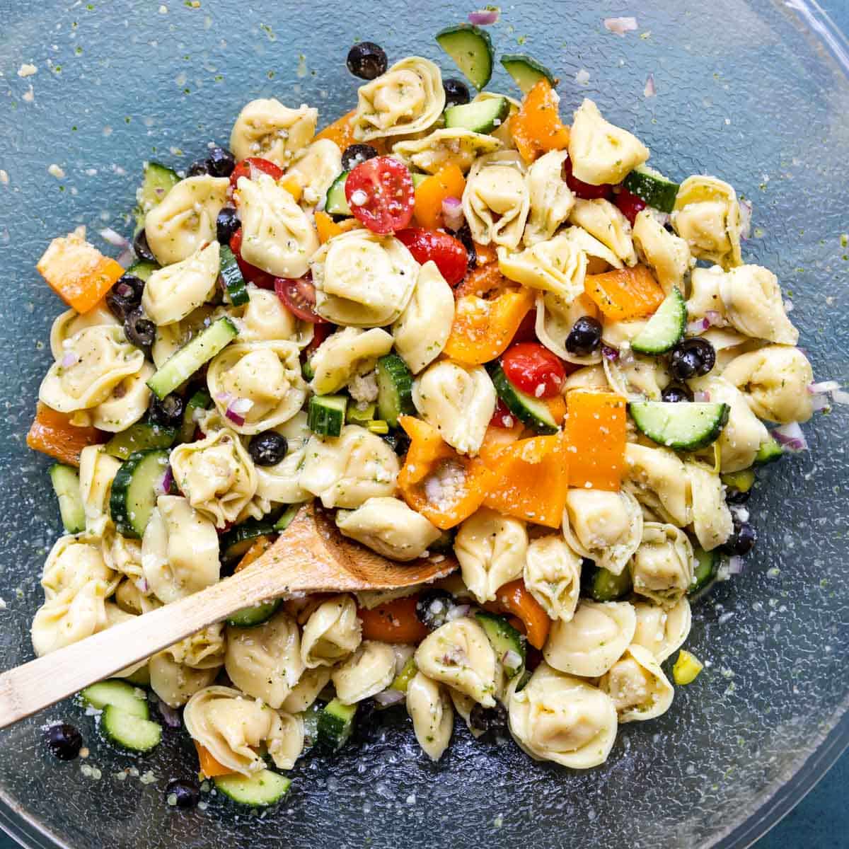 cheese tortellini with veggies, dressing and parmesan cheese
