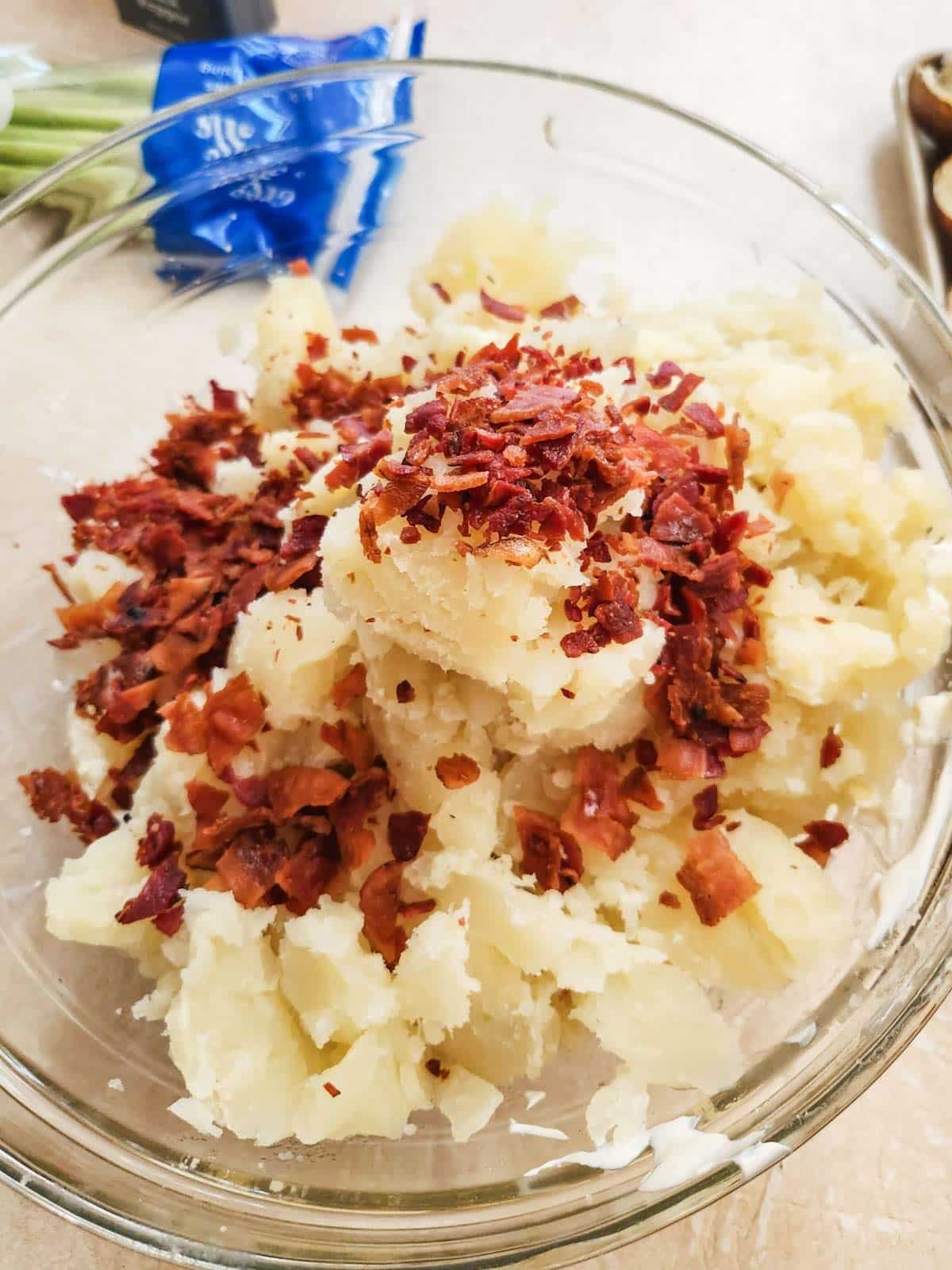 potatoes, bacon, sour cream, butter, garlic and spices in a bowl