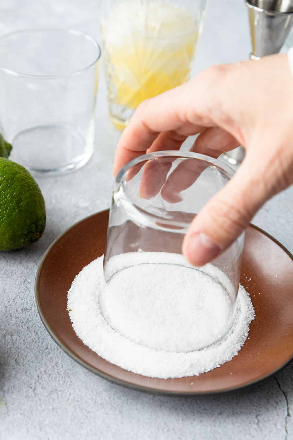 dipping a glass in a plate full of kosher salt