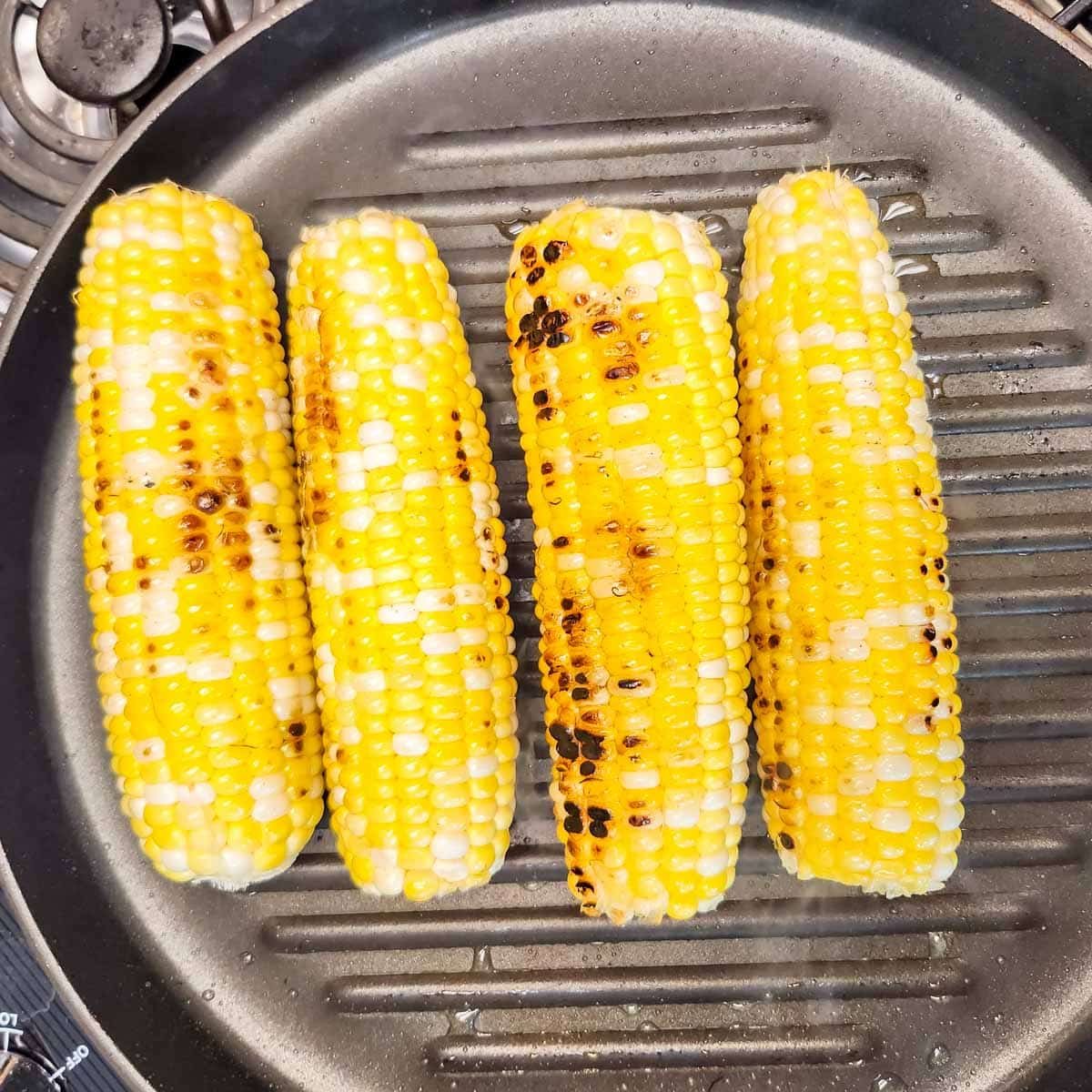 ears of corn in a grill pan