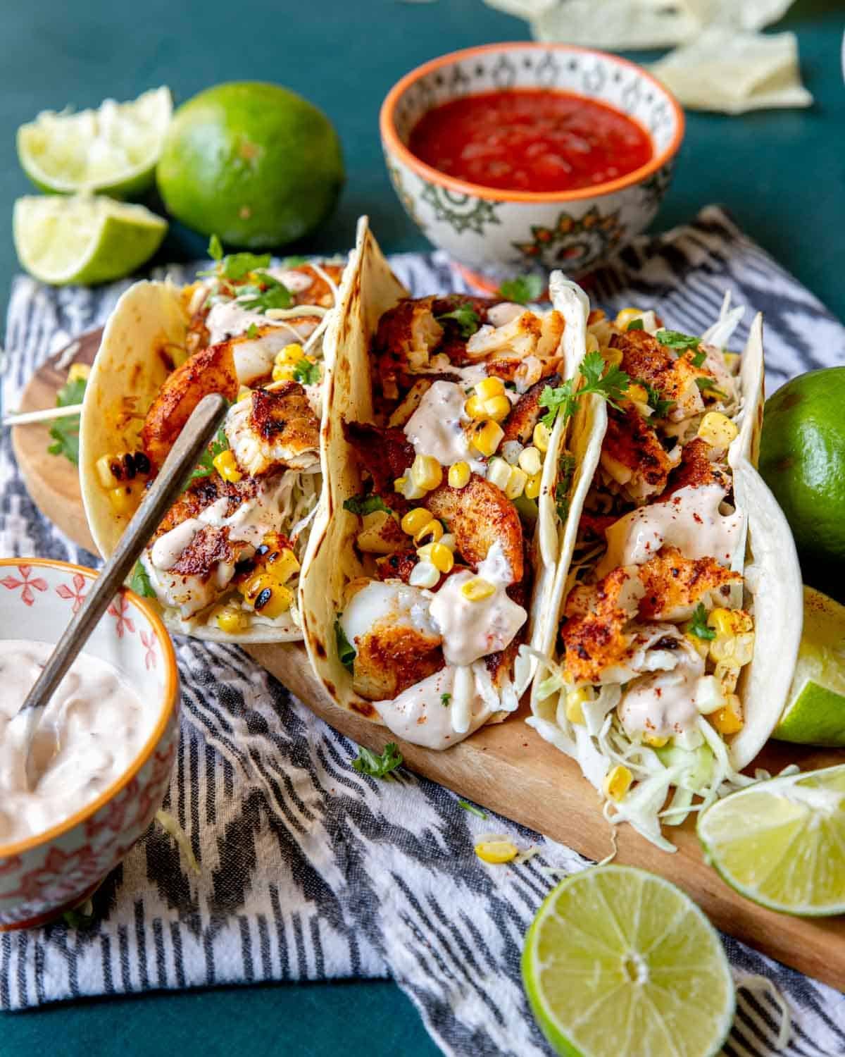 Three Tilapia fish tacos topped with chipotle crema