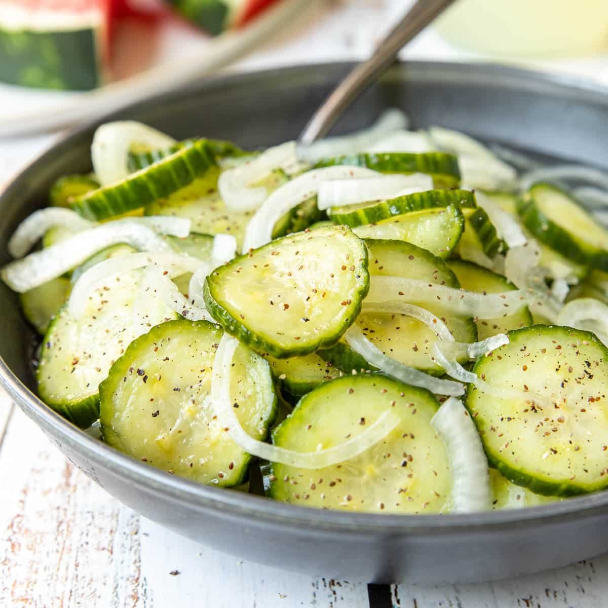 Cucumbers and Onions Salad in a bowl with a fork