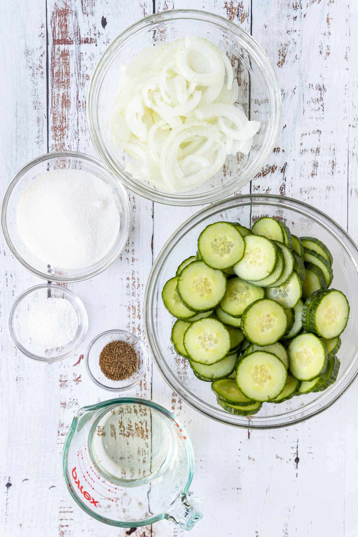 Ingredients for cucumber and onion salad on a table