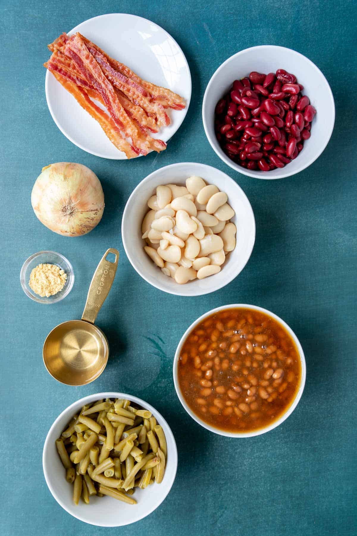 Ingredients for bean casserole in bowls on a table 