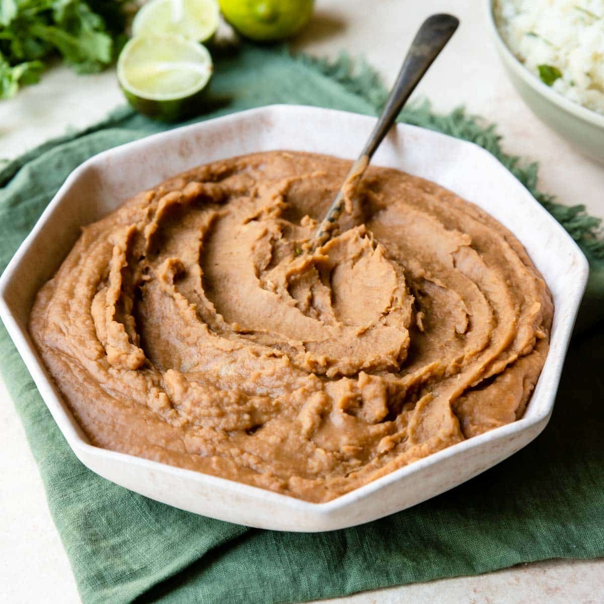 refried beans in a bowl with a spoon