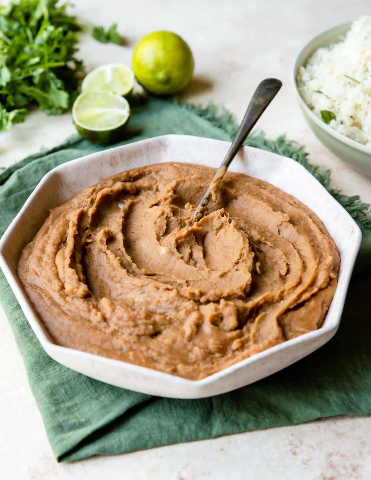 a large bowl of refried beans and a spoon to serve 
