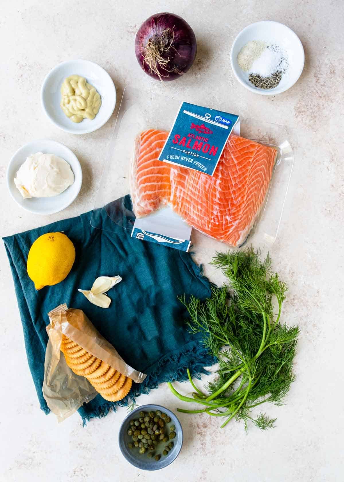 ingredients for salmon burgers on a table