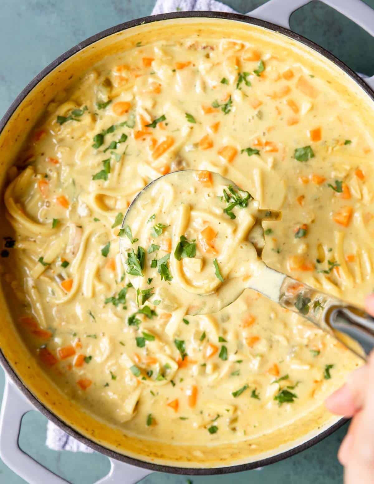 large dutch oven full of creamy chicken noodle soup