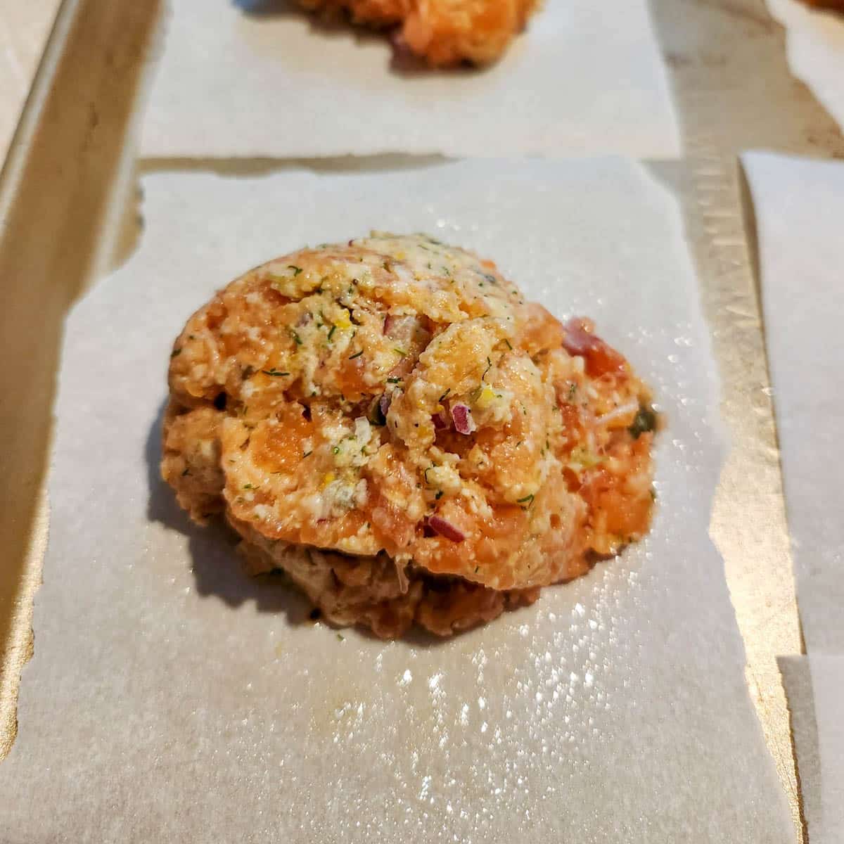 ½ cup portion of salmon patty mixture on wax paper 