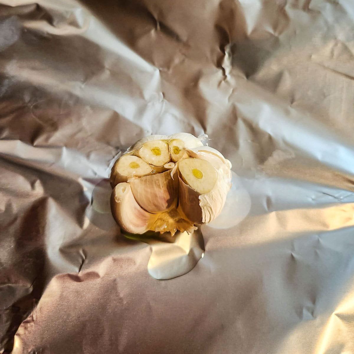 garlic head in foil with oil