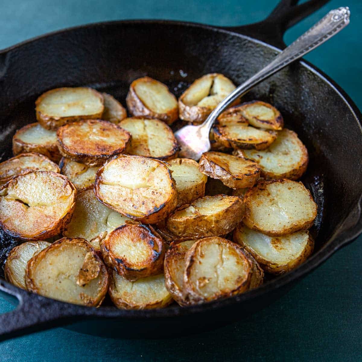 Leftover baked potatoes sliced and sauteed in a skillet