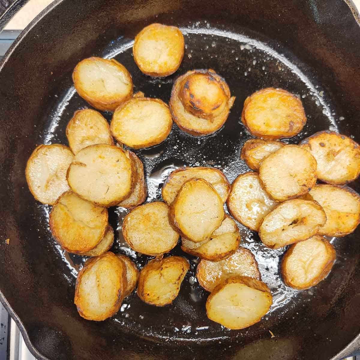 sliced leftover baked potatoes in a skillet