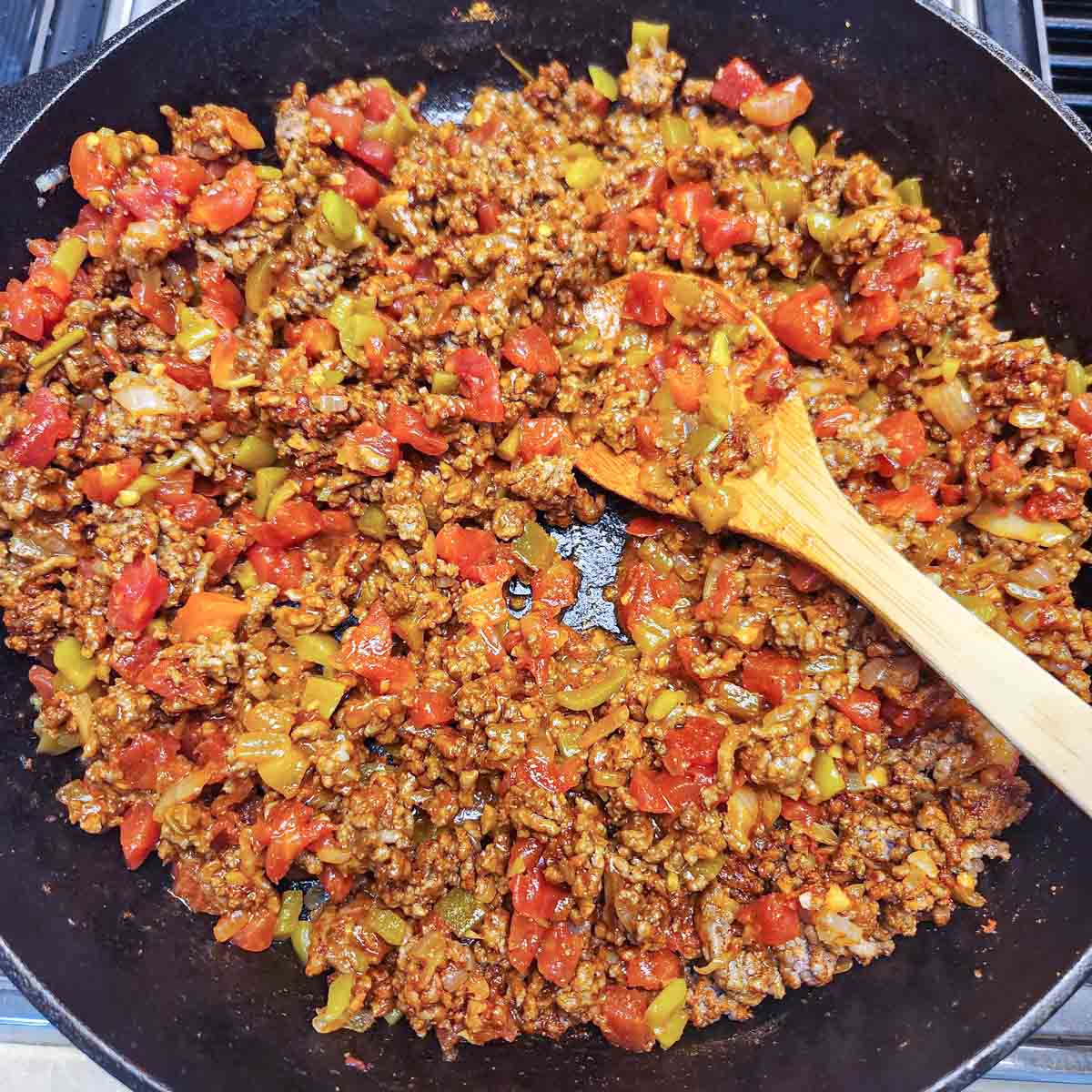ground beef, onions, garlic, tomatoes and chilies in a skillet