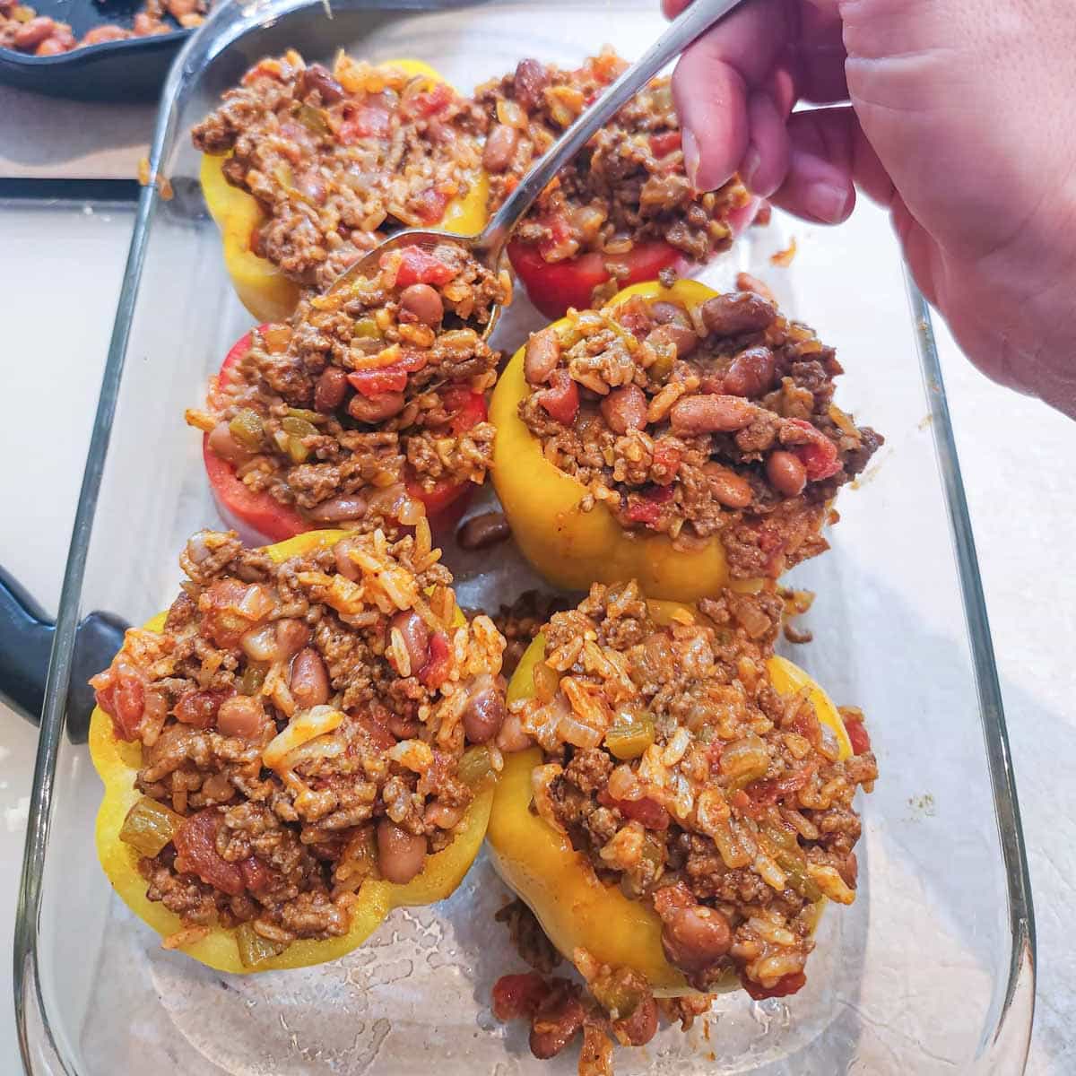 spoon ground beef mixture in bell peppers 