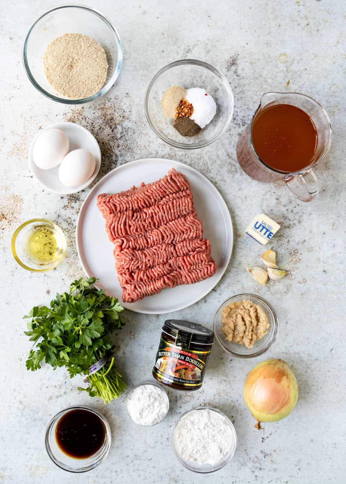 Ingredients for meatballs and gravy on a table 