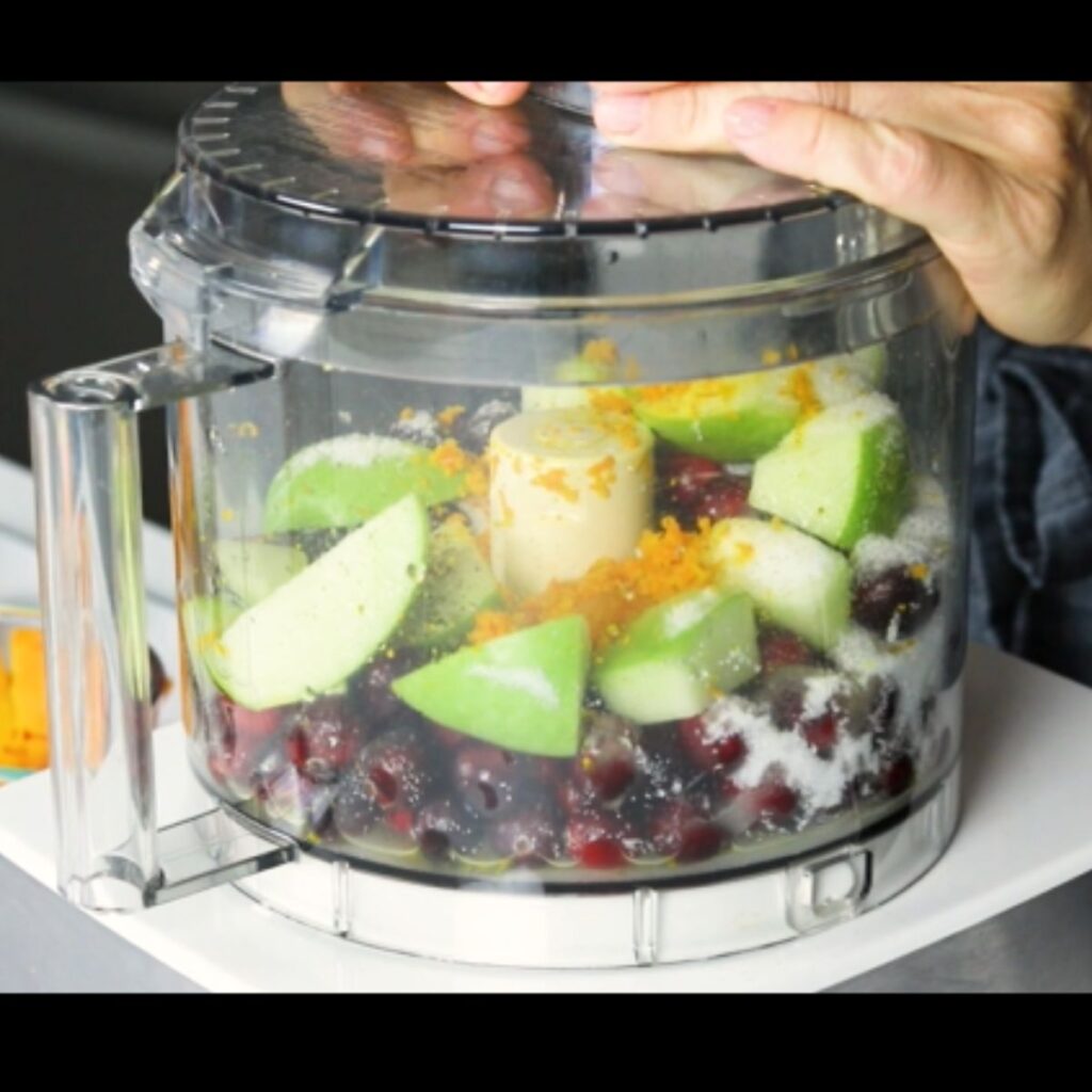 Ingredients for cranberry relish in a food processor