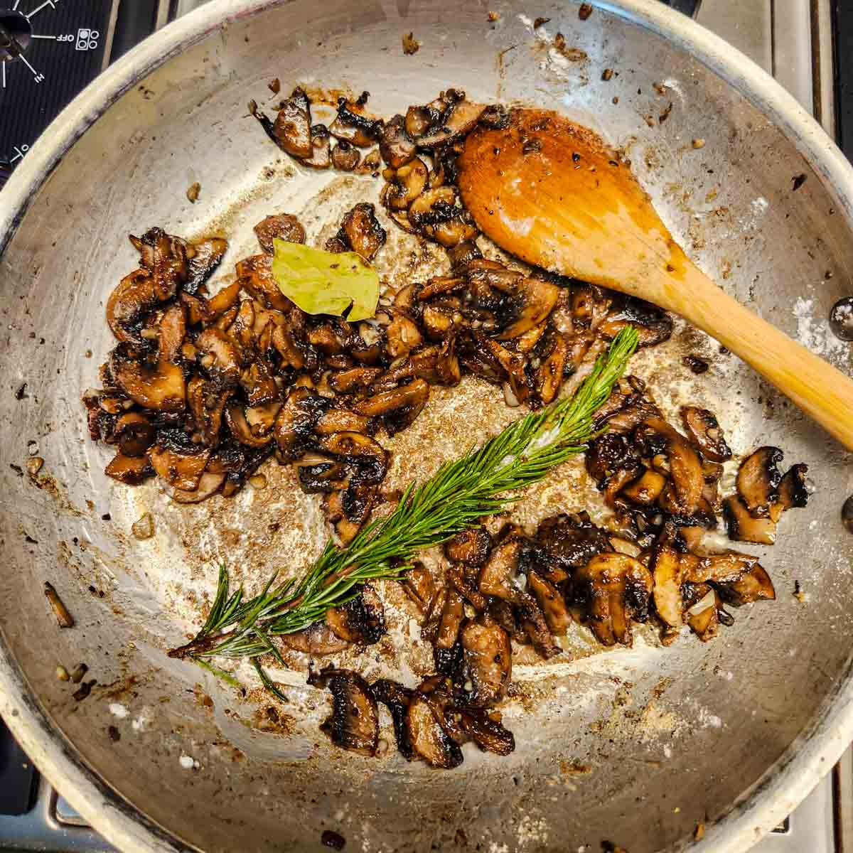 mushrooms and herbs in a skillet