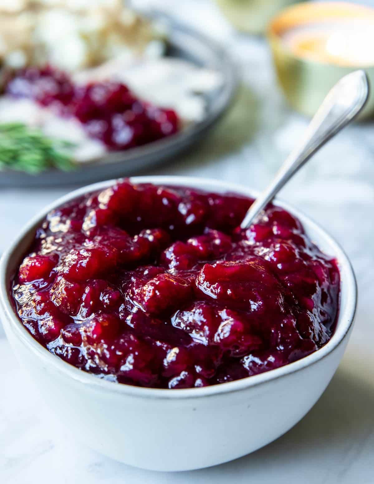 a large bowl of cranberry sauce on a thanksgiving table