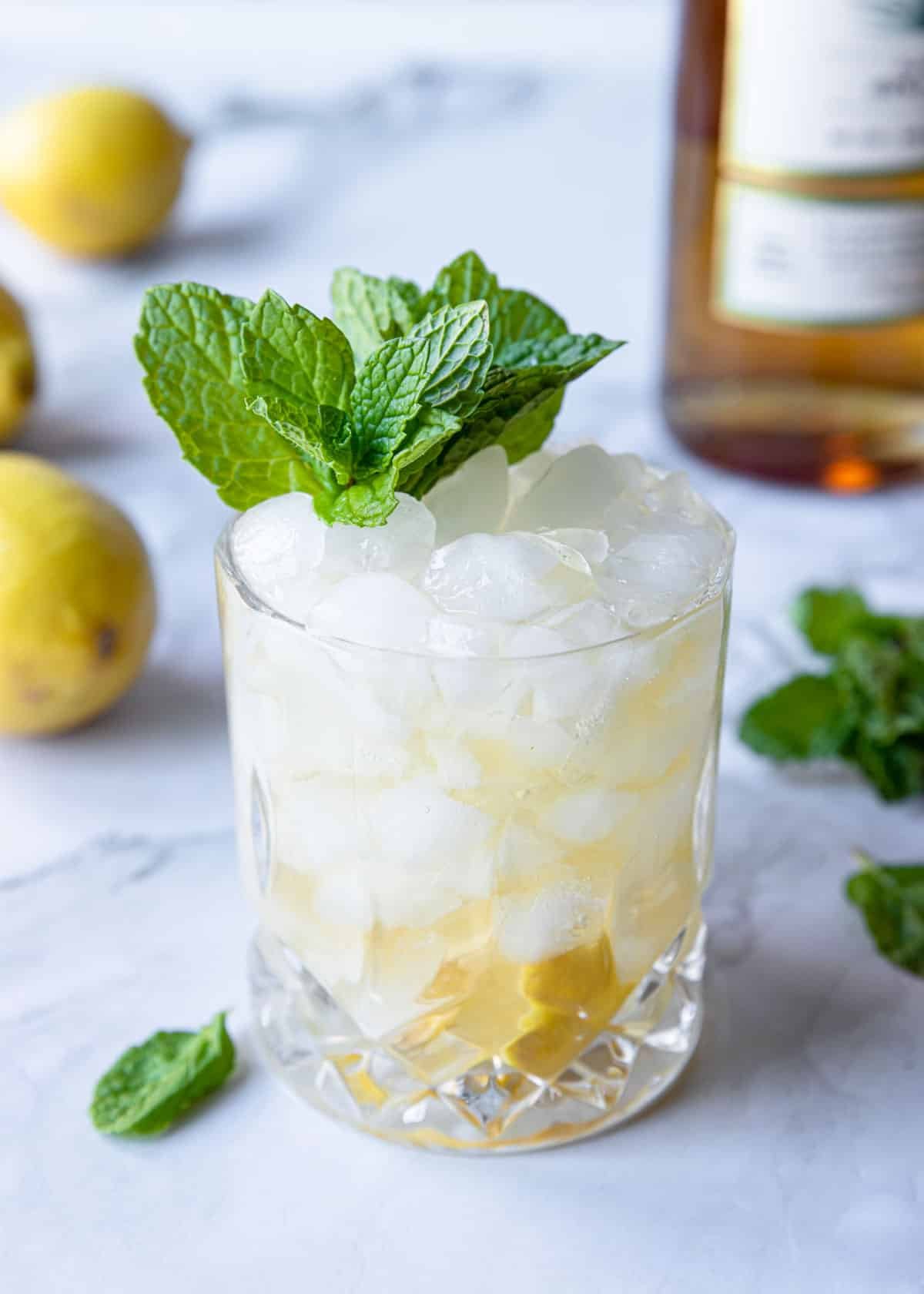 tequila smash in a glass of crushed ice with fresh mint on top