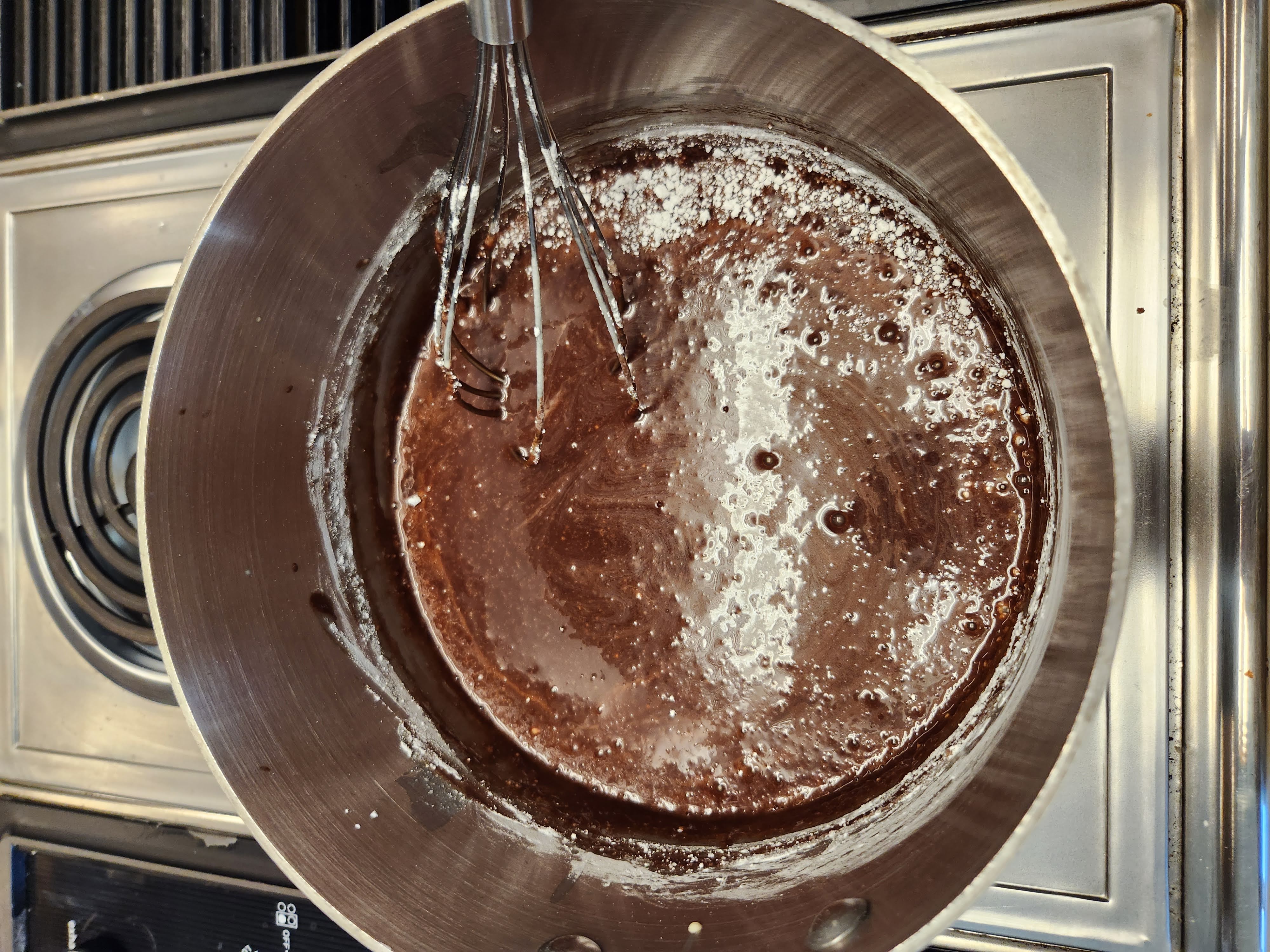 hot fudge sauce boiling on a stove top