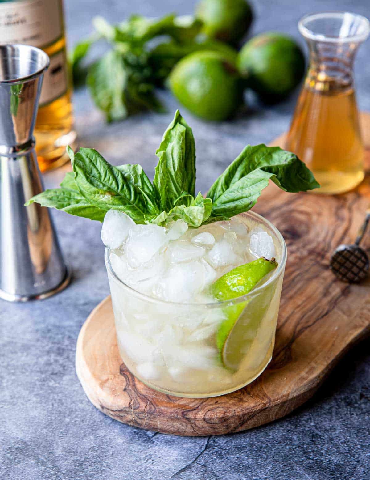 Tequila Basil Smash in a glass with crushed ice and fresh basil garnish