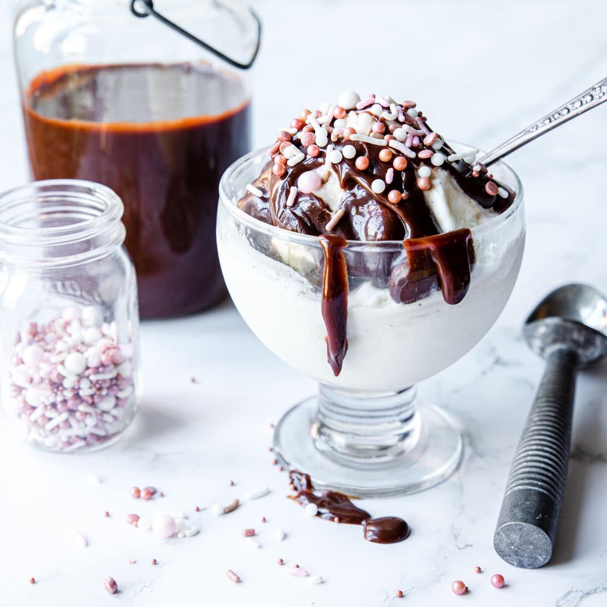 vanilla ice cream with homemade hot fudge sauce and sprinkles over top