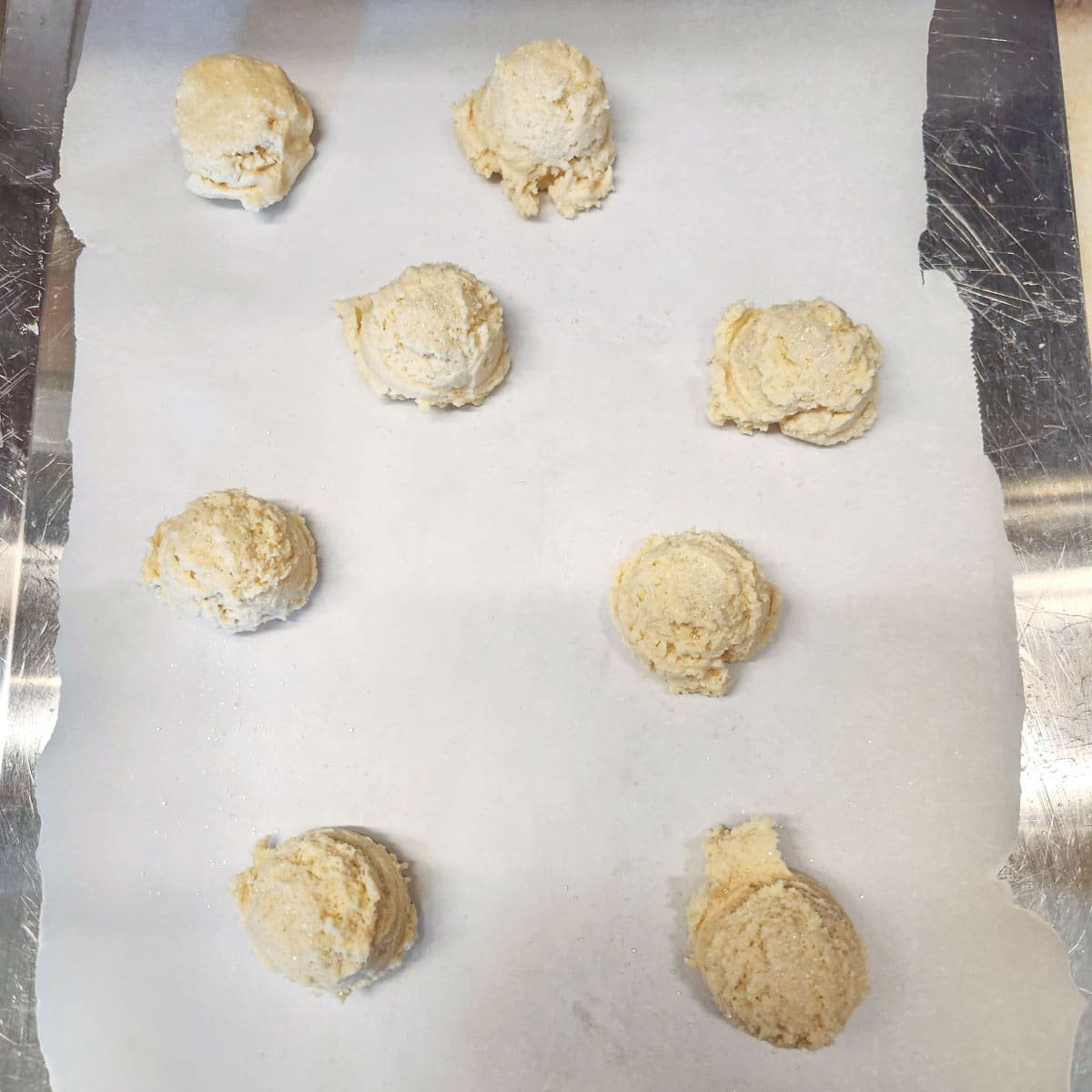 cookie dough on a parchment lined cookie sheet