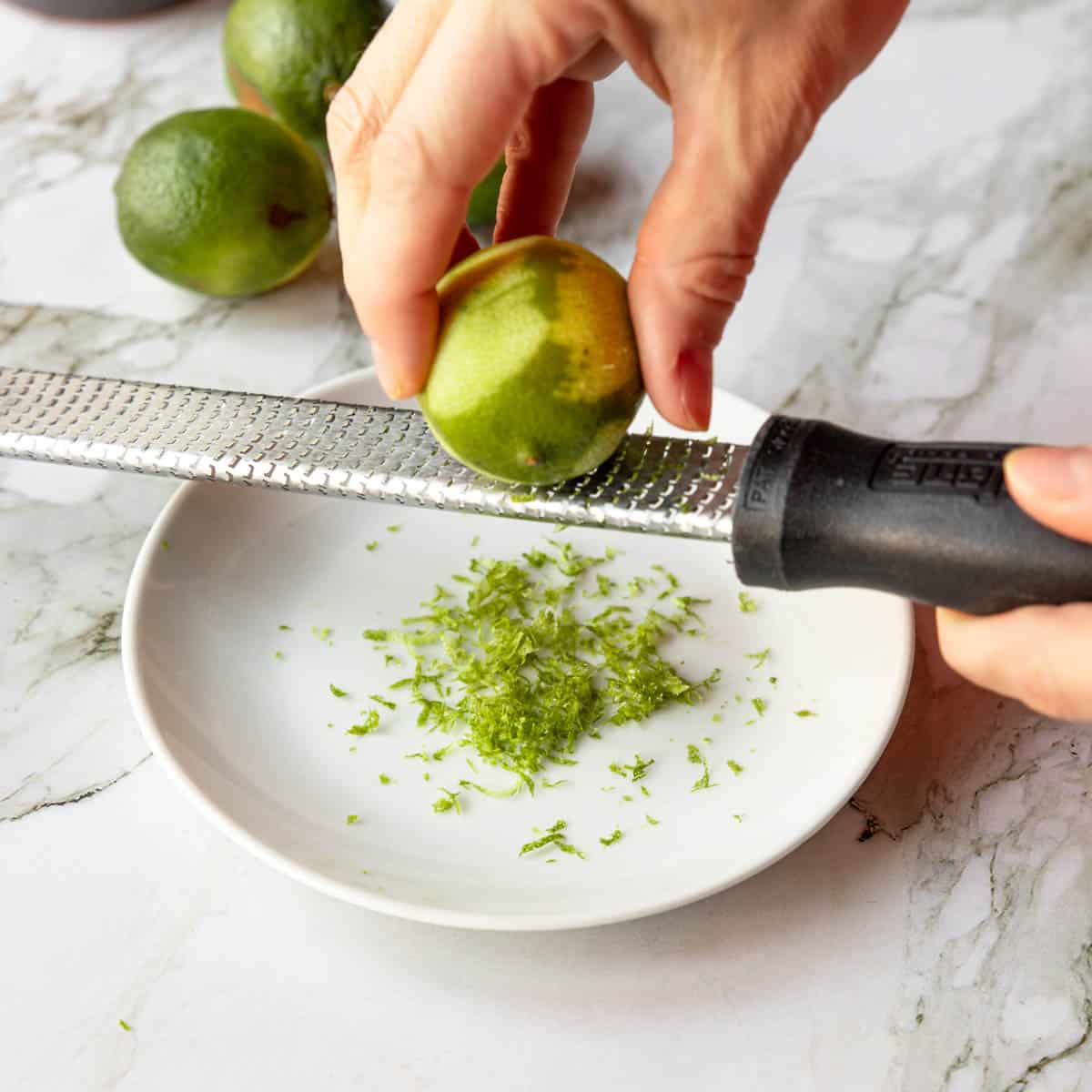 zesting a lime on a microplane