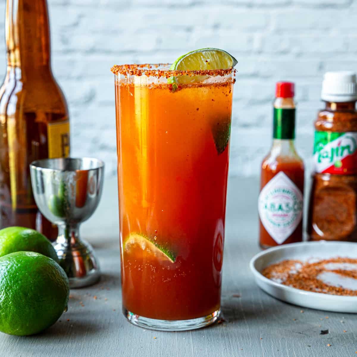 Michelada in a tall glass with Tajin on the rim of the glass
