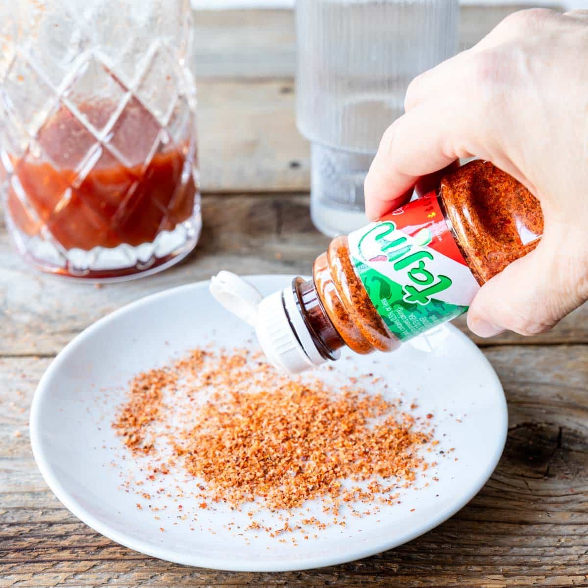 Tajin being poured on a plate 
