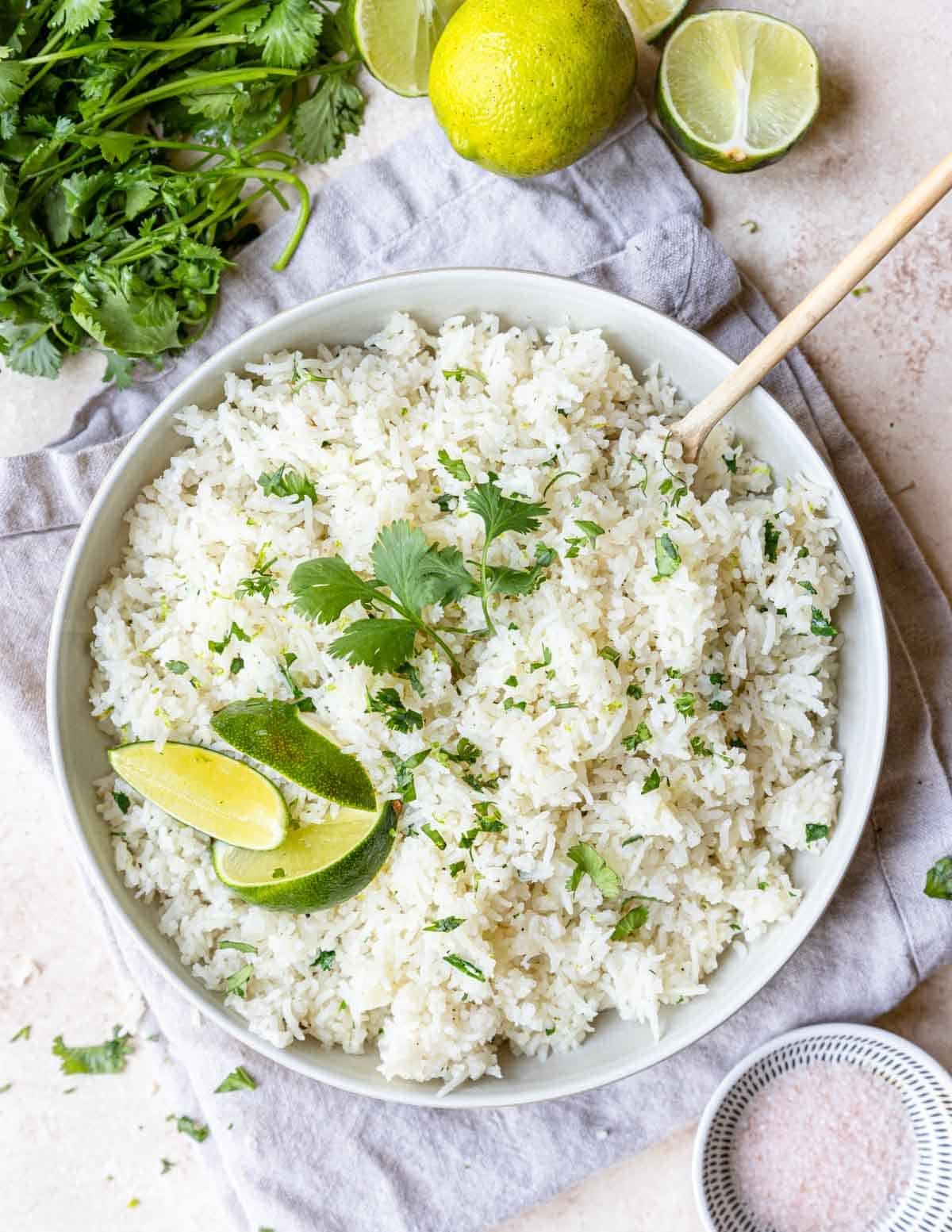 Cilantro Rice in a large bowl with lime and cilantro on top