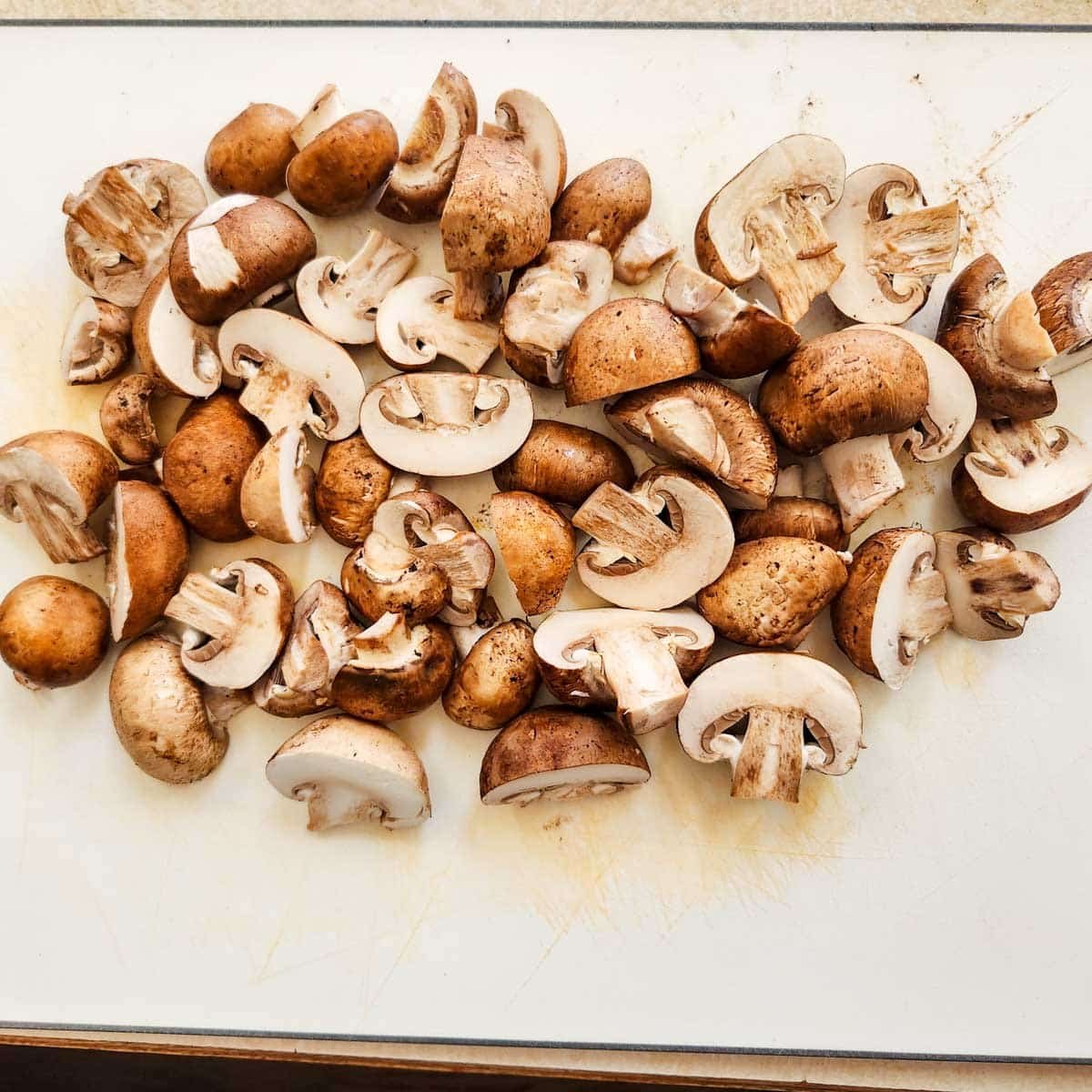 baby bella (cremini) mushrooms on a cutting board