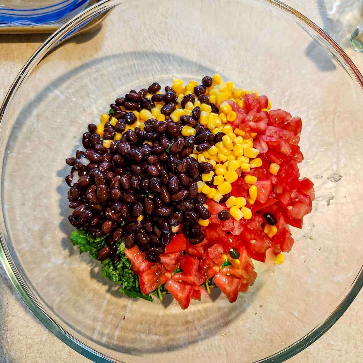 black beans, corn, tomatoes, cilantro and onion in a bowl