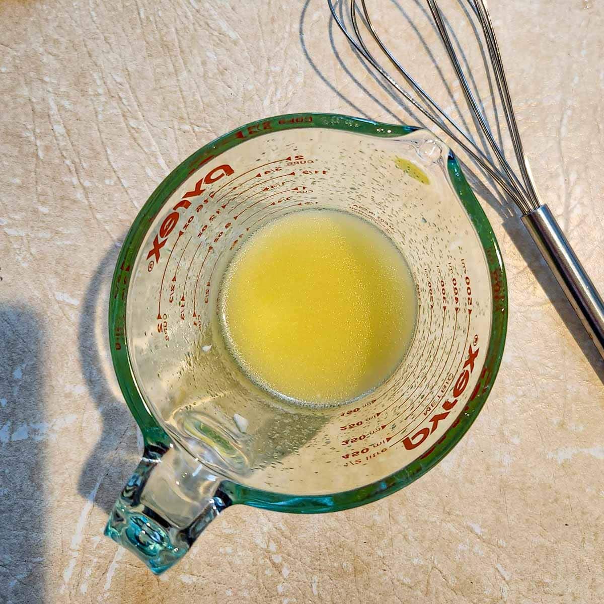 lime and olive oil in a glass measuring cup
