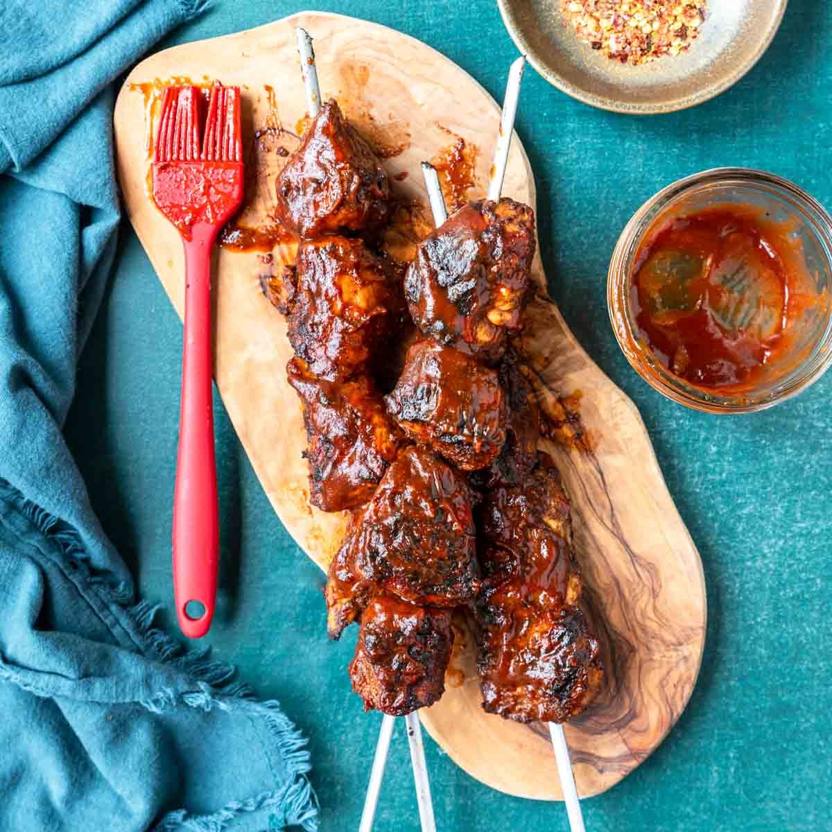 bbq marinated and grilled chicken skewers on a cutting board