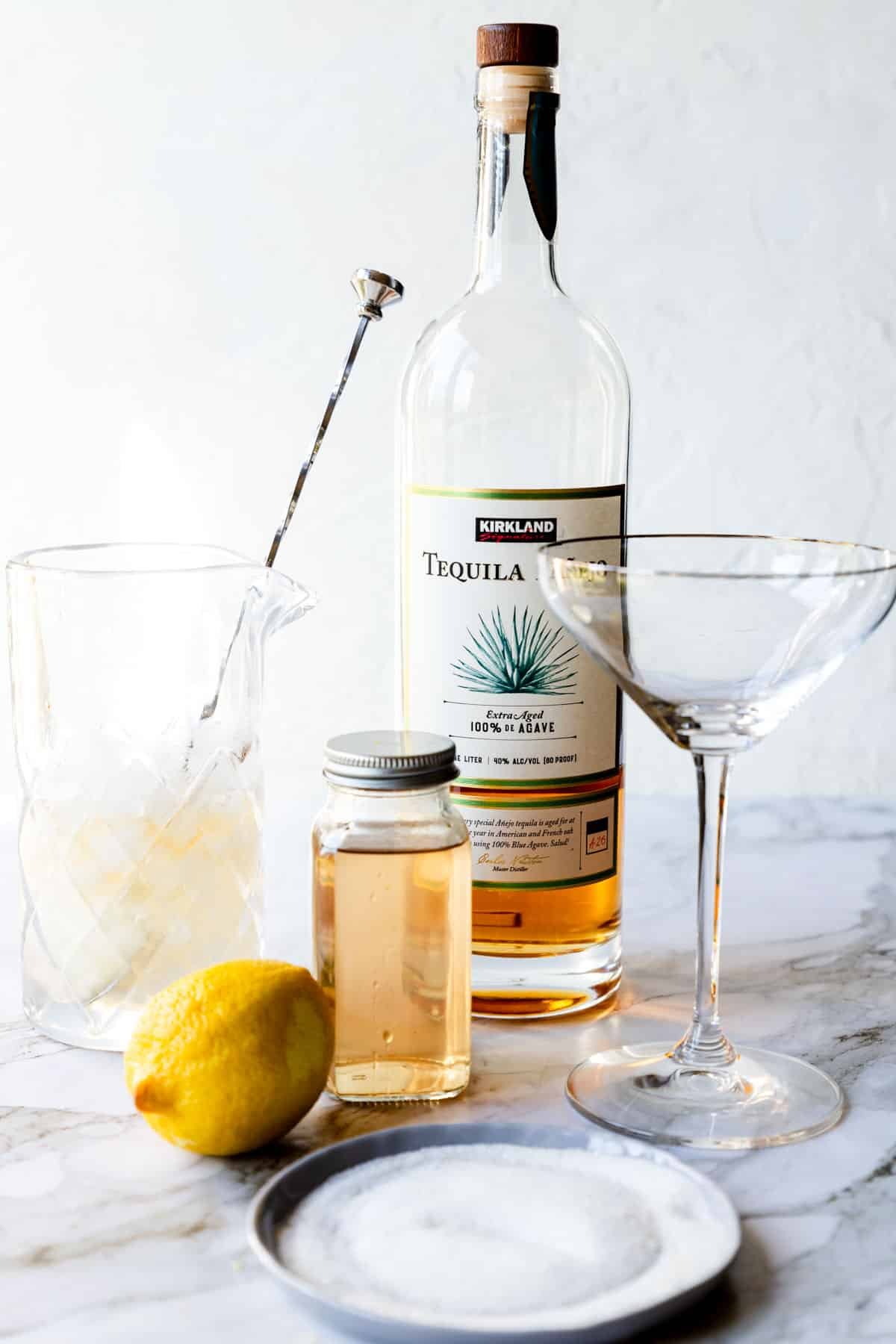 ingredients for a tequila cinnamon lemon drop on a table