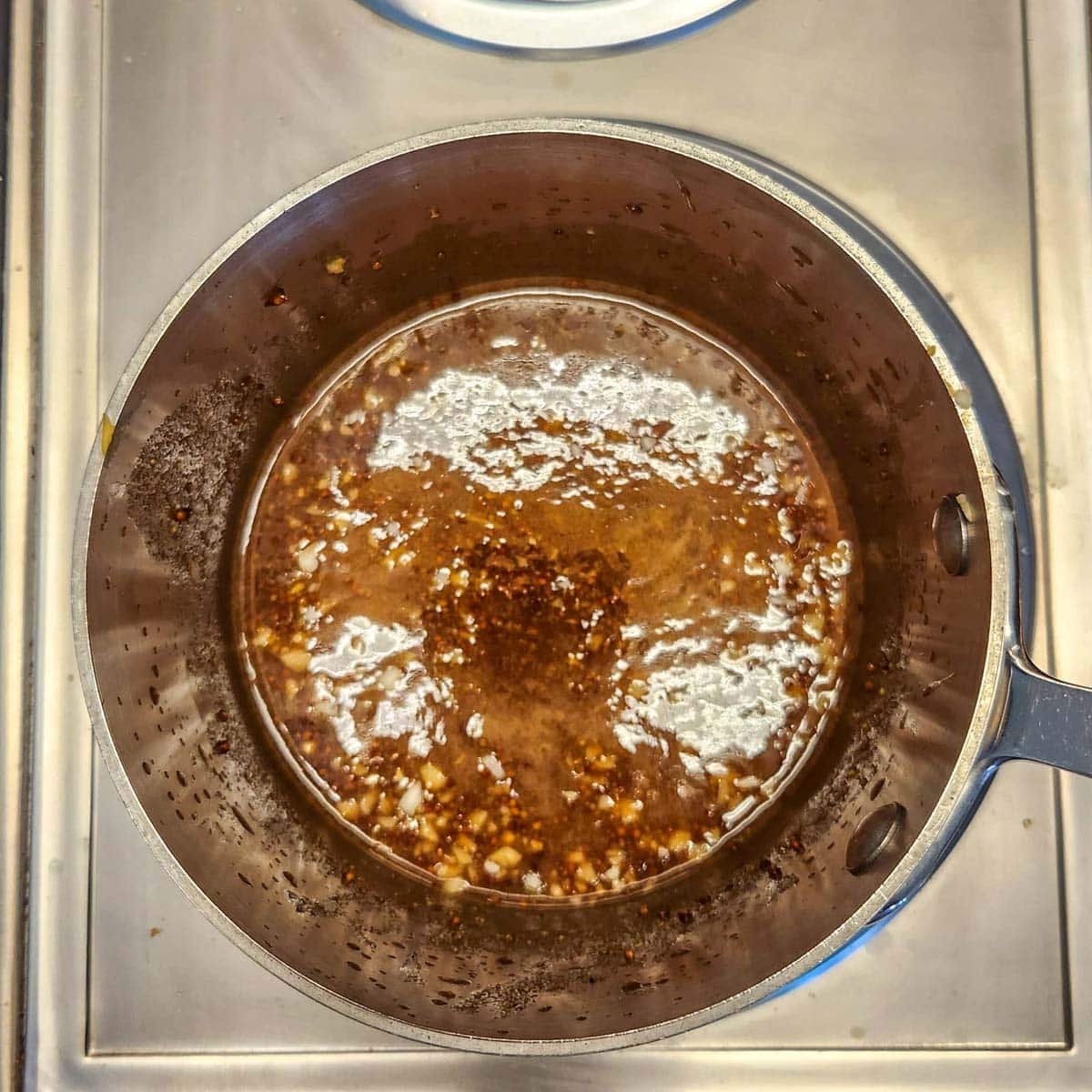 simmering brown sugar and mustard ham glaze on the stove top