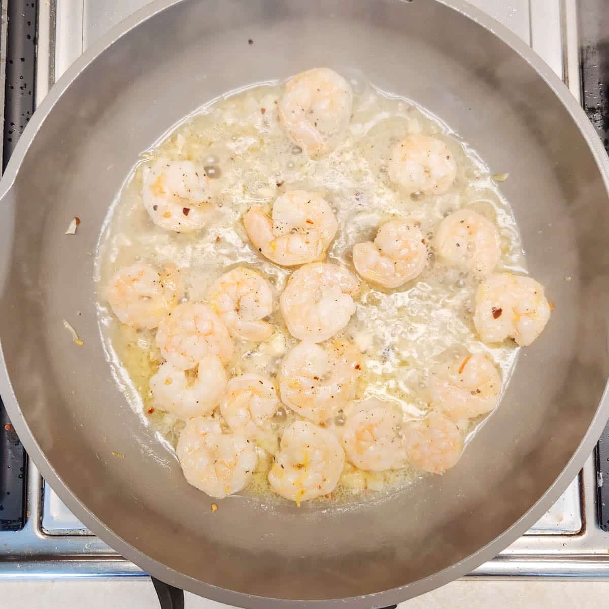 shrimp with white wine, garlic and butter in a skillet