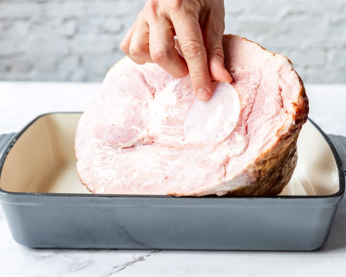 removing the plastic cap on the bone of a spiral cut ham
