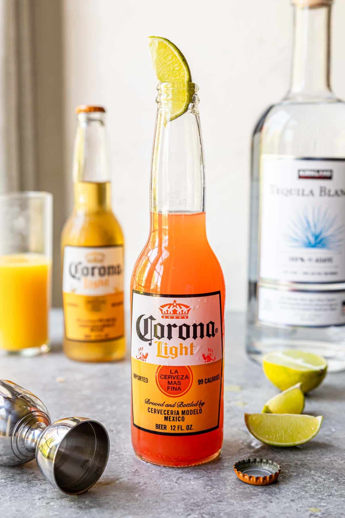 Corona Sunrise in a Corona Light bottle on a table with a lime in the top of the bottle