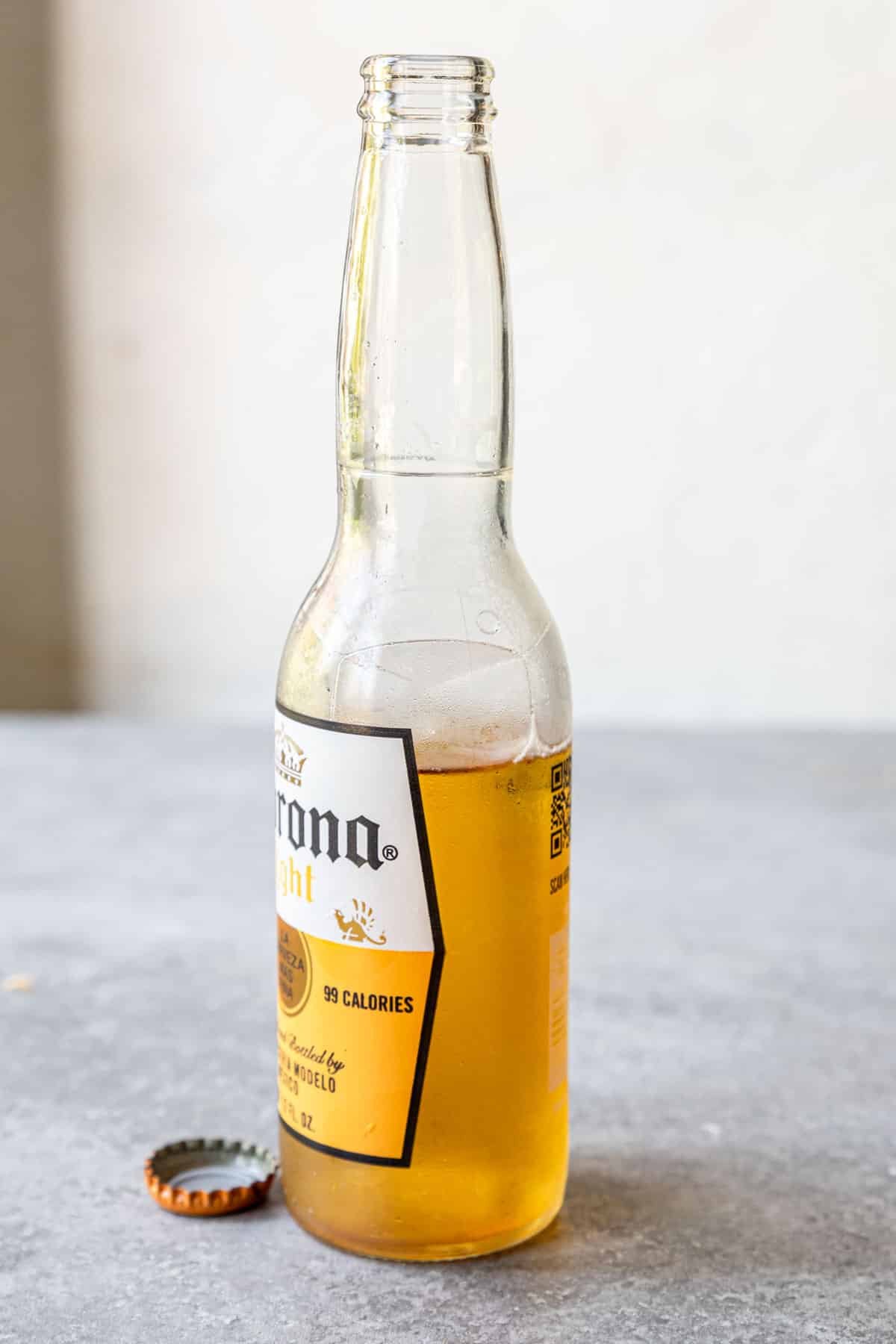 A Corona bottle with about ¼ of the bottle gone