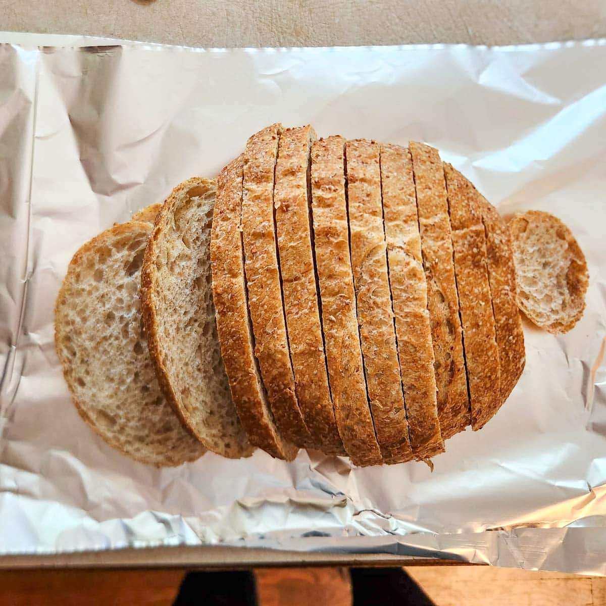 a sliced loaf of sourdough on a large piece of foil
