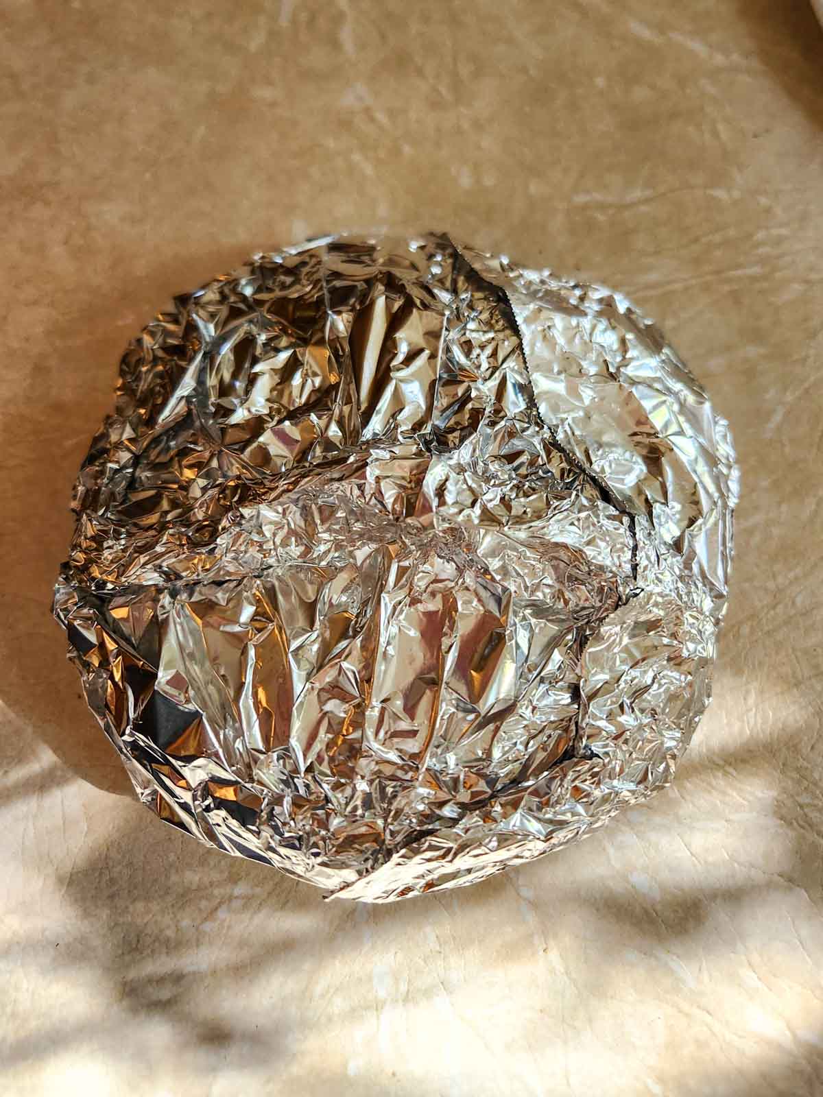 a loaf of garlic bread wrapped in foil