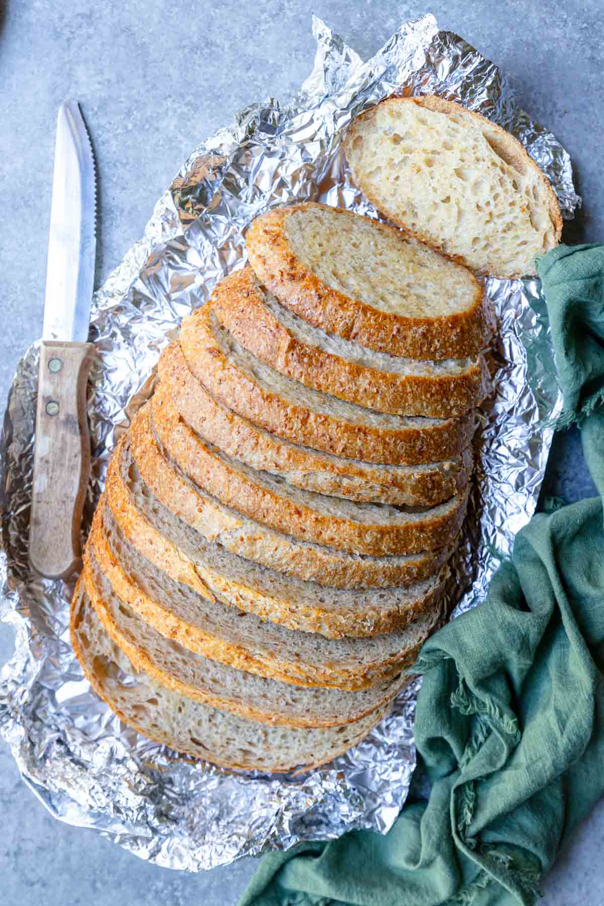 soft garlic bread that is spread out on a piece of foil