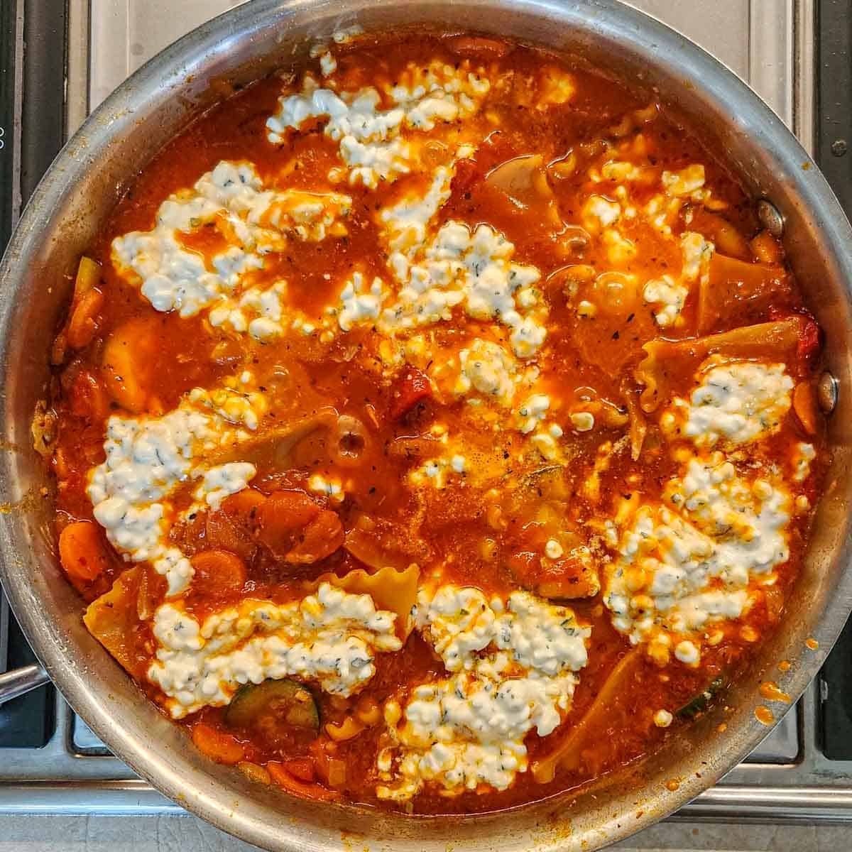 veggie lasagna skillet dotted with cottage cheese 