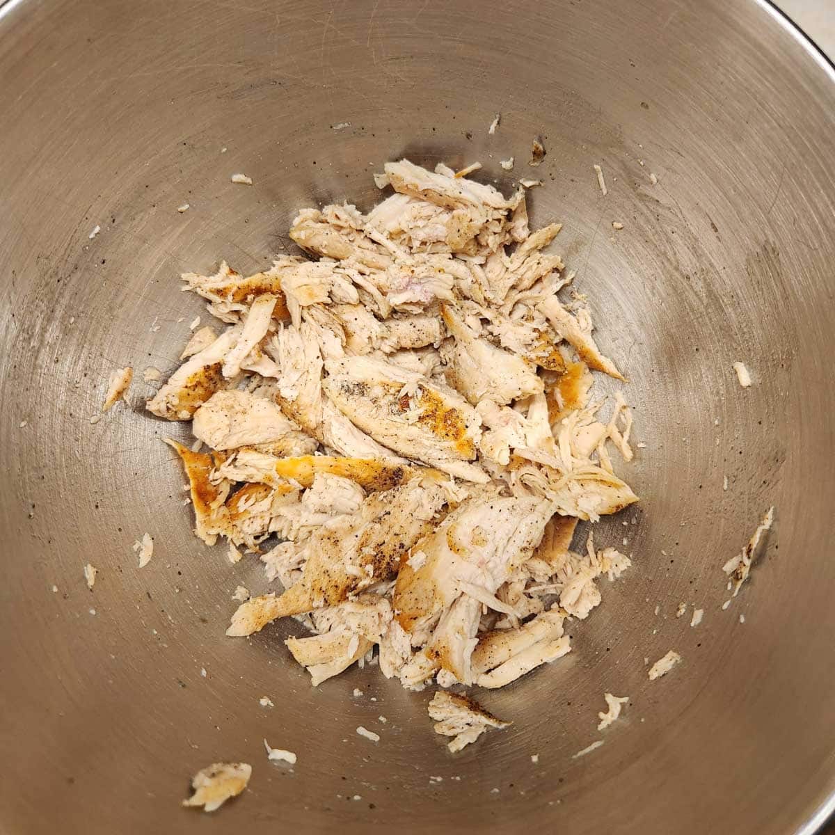 shredded chicken in the bowl of a stand mixer